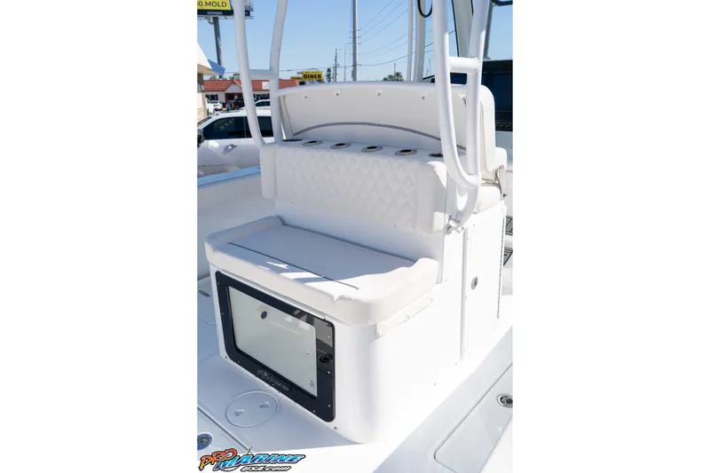 Slide: The Image of 2026 Sea Hunt Ultra 285 SE boat seating area with storage compartment. - 29
