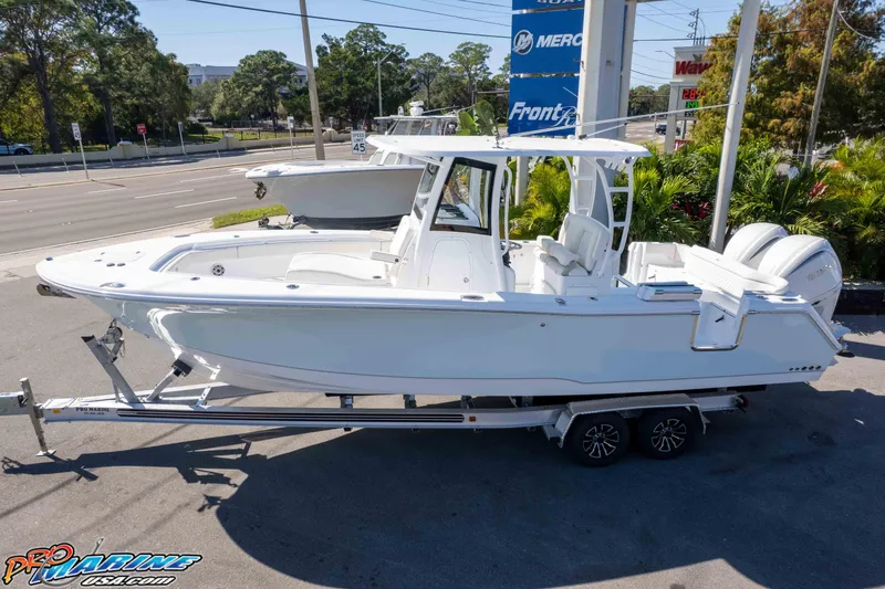 Slide: The Image of 2026 Sea Hunt Ultra 285 SE boat on trailer, parked outdoors. - 3