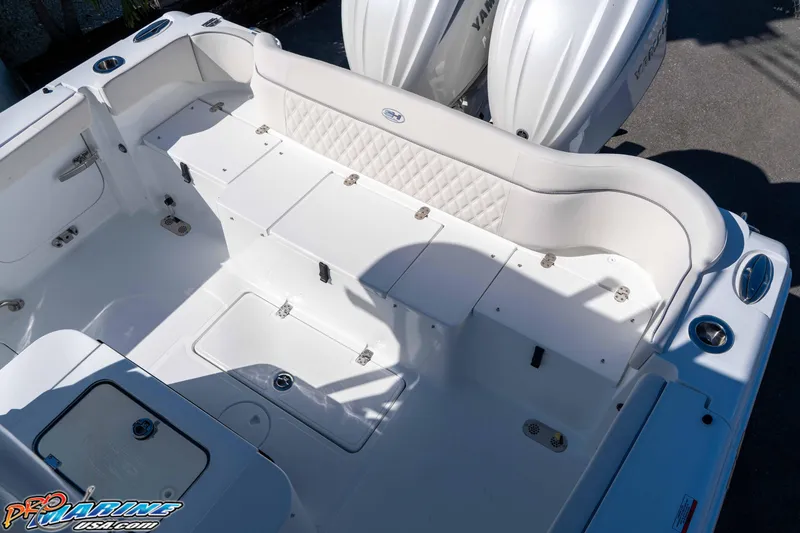 Slide: The Image of 2026 Sea Hunt Ultra 285 SE boat interior with white seating and storage compartments. - 30