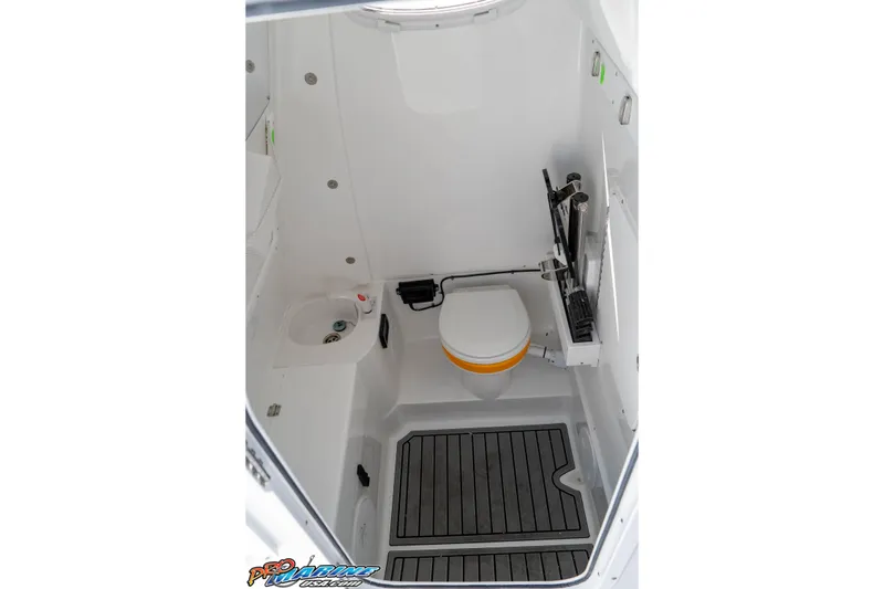 Slide: The Image of Interior of 2026 Sea Hunt Ultra 285 SE boat, featuring a compact marine bathroom. - 33