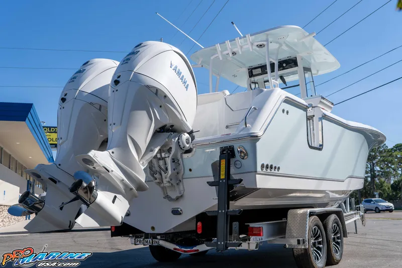 Slide: The Image of 2026 Sea Hunt Ultra 285 SE boat with dual Yamaha engines on a trailer. - 8