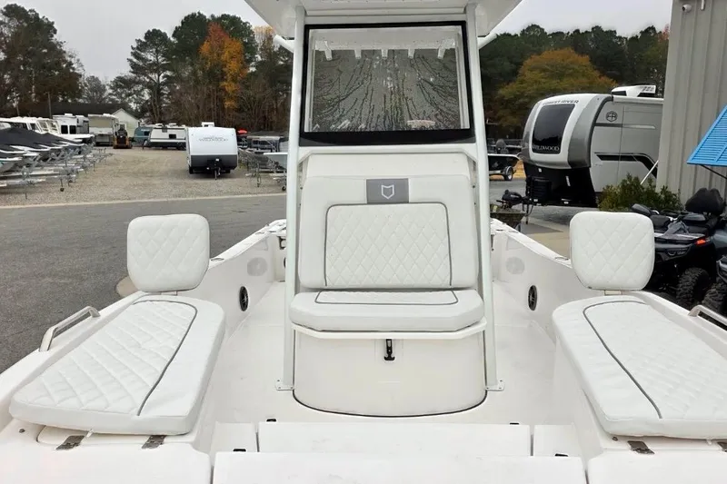 Slide: The Image of 2026 Sea Fox 231 Bay Fox boat interior with white cushioned seating. - 11