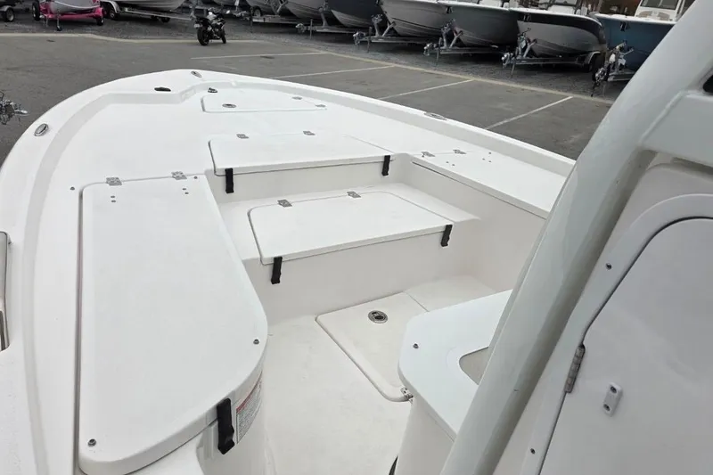 Slide: The Image of 2026 Sea Fox 231 Bay Fox boat interior with storage compartments, parked in a lot. - 13