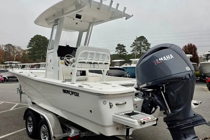 Slide: The Image of 2026 Sea Fox 231 Bay Fox boat with Yamaha outboard motor, parked on a trailer. - 17