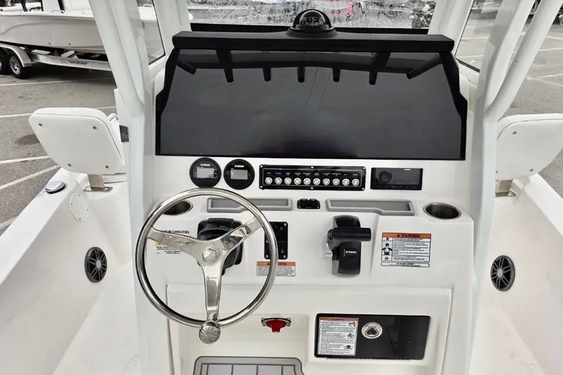 Slide: The Image of 2026 Sea Fox 231 Bay Fox boat dashboard with steering wheel and controls. - 4