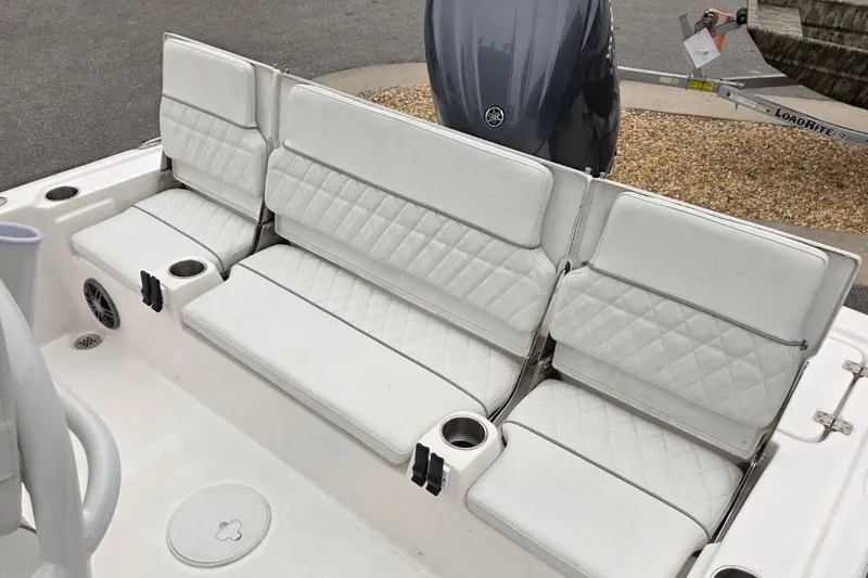 Slide: The Image of 2026 Sea Fox 231 Bay Fox boat with white cushioned seating and cup holders. - 6
