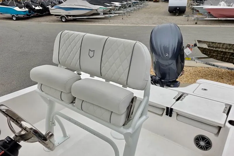 Slide: The Image of 2026 Sea Fox 231 Bay Fox boat interior with cushioned seating and steering wheel. - 7