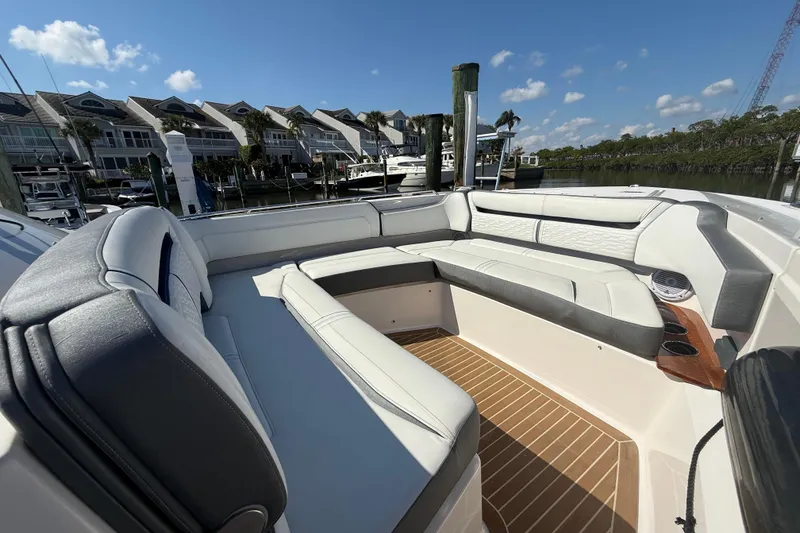 Slide: The Image of 2019 Tiara Sport 38 LS boat with luxurious seating and waterfront view. - 15