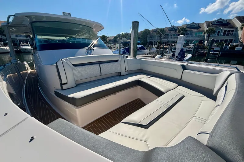 Slide: The Image of 2019 Tiara Sport 38 LS luxury yacht with spacious seating in a marina setting. - 16