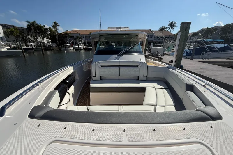 Slide: The Image of 2019 Tiara Sport 38 LS boat with spacious seating at a marina dock. - 18