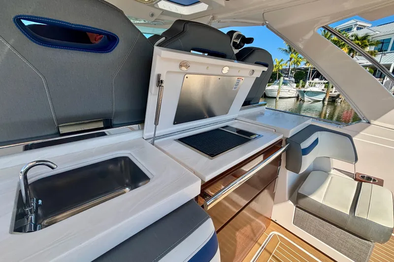 Slide: The Image of Luxurious 2019 Tiara Sport 38 LS yacht interior with kitchenette and seating area. - 20