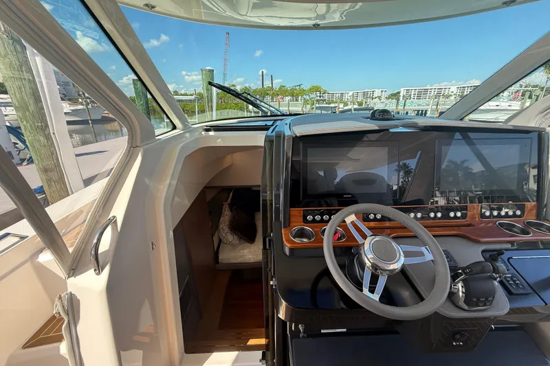 Slide: The Image of 2019 Tiara Sport 38 LS boat helm with modern controls and navigation screens. - 21