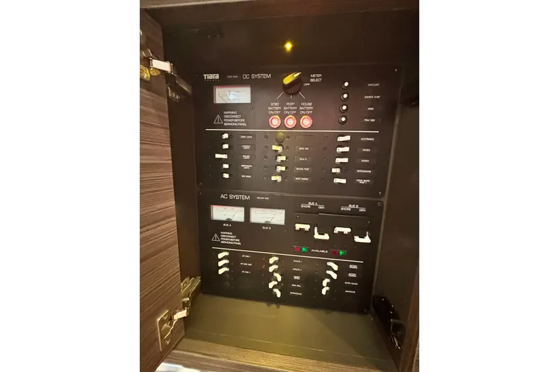 Slide: The Image of Electrical control panel of 2019 Tiara Sport 38 LS boat, featuring AC and DC systems. - 28