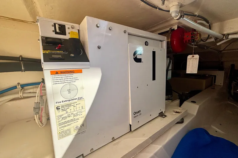 Slide: The Image of 2019 Tiara Sport 38 LS engine room with Cummins Onan Marine generator. - 29