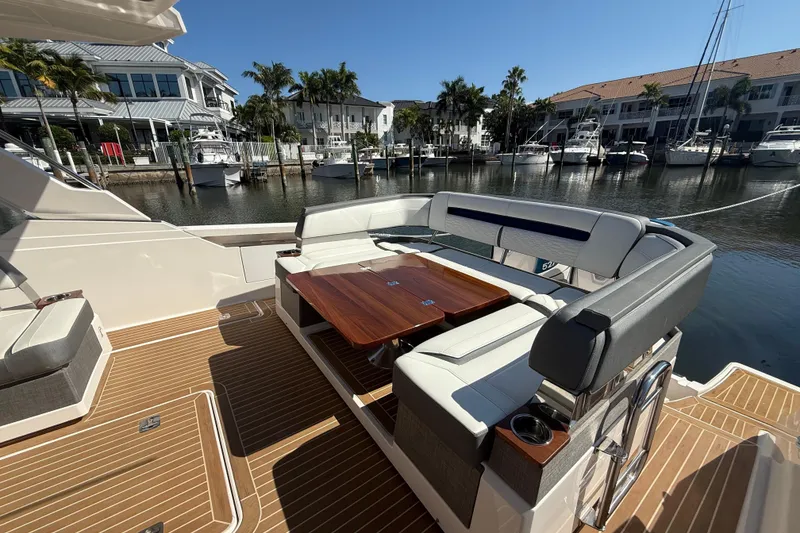 Slide: The Image of Luxury seating area on 2019 Tiara Sport 38 LS yacht, docked in a marina. - 3