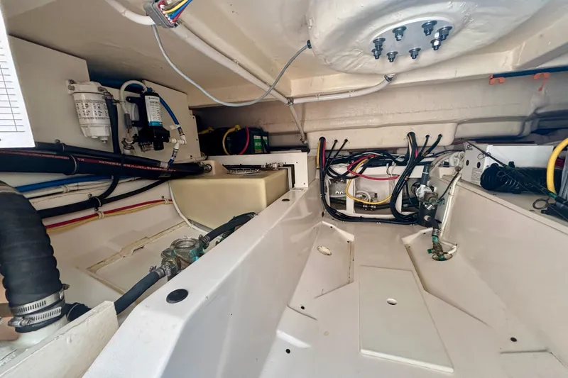 Slide: The Image of Engine compartment of a 2019 Tiara Sport 38 LS boat, showcasing wiring and components. - 30