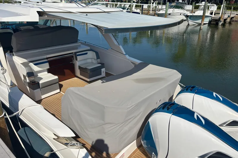 Slide: The Image of 2019 Tiara Sport 38 LS yacht with covered seating and twin engines docked at marina. - 33