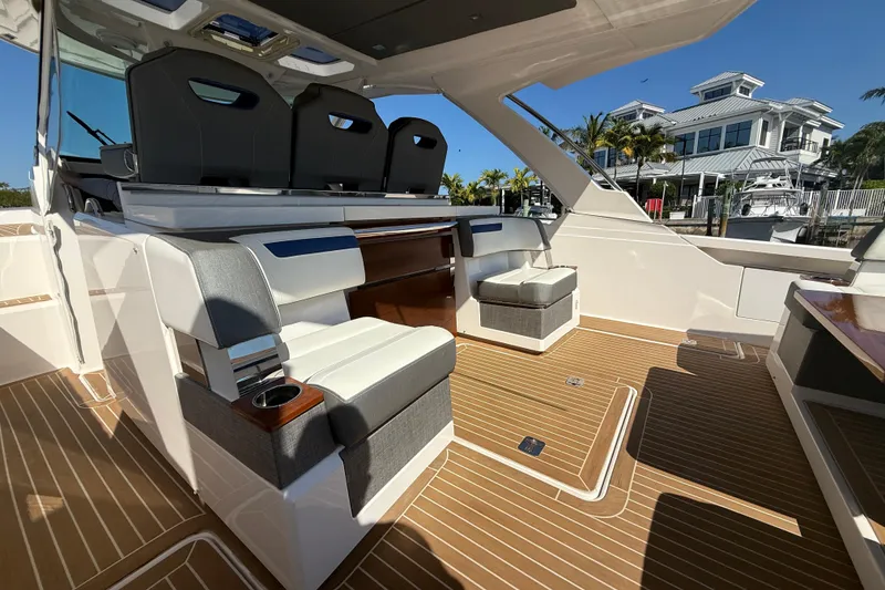 Slide: The Image of 2019 Tiara Sport 38 LS boat interior with luxurious seating and teak flooring. - 5