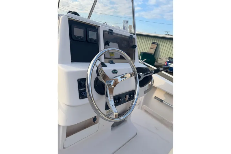 Slide: The Image of 2006 Grady-White Sportsman 180 boat steering console with controls and gauges. - 5
