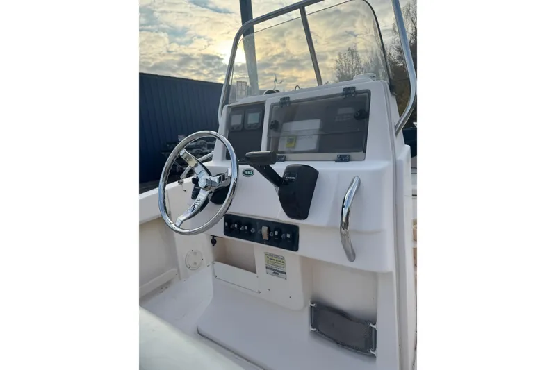 Slide: The Image of 2006 Grady-White Sportsman 180 boat console with steering wheel and controls. - 8