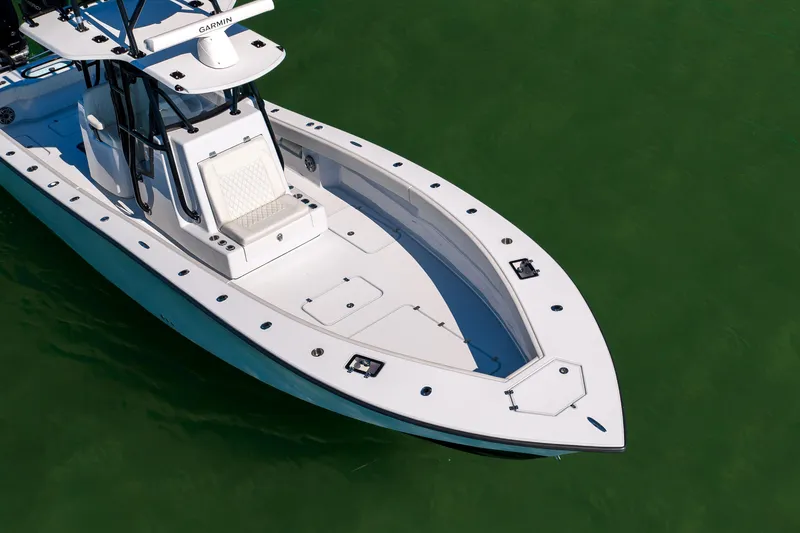 Slide: The Image of 2025 Conch 33 boat on green water, featuring sleek design and modern equipment. - 11