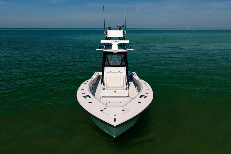 Slide: The Image of 2025 Conch 33 boat on calm ocean waters, viewed from the front. - 12