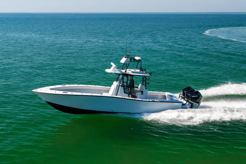 Slide: The Image of 2025 Conch 33 boat cruising on open water, showcasing sleek design and powerful engines. - 15