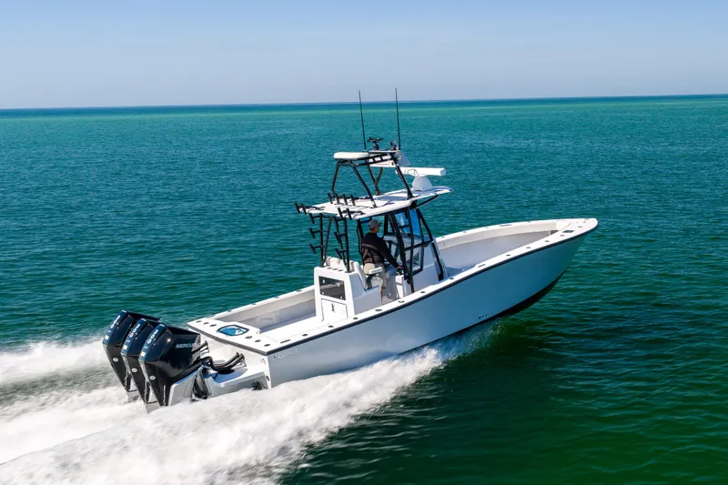 Slide: The Image of 2025 Conch 33 boat cruising on open water with dual engines. - 21