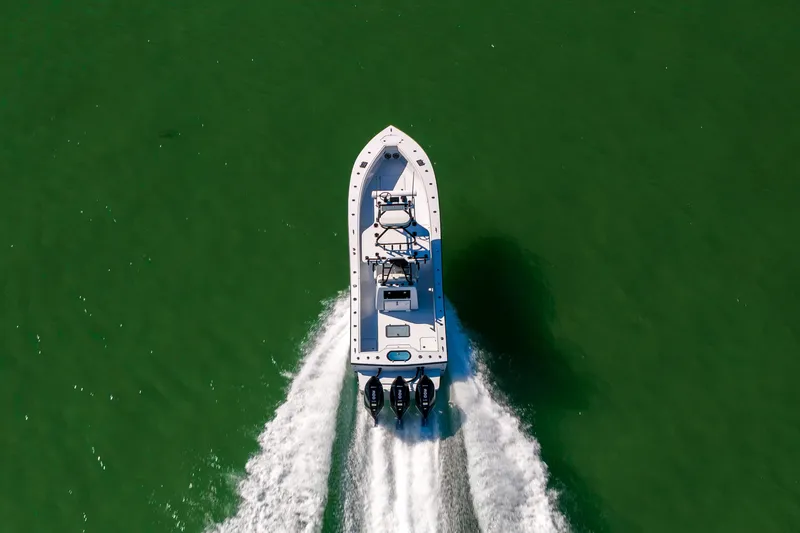 Slide: The Image of Aerial view of 2025 Conch 33 boat cruising on green water. - 23