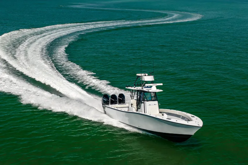 Slide: The Image of 2025 Conch 33 boat cruising on open water, leaving a curved wake trail. - 26