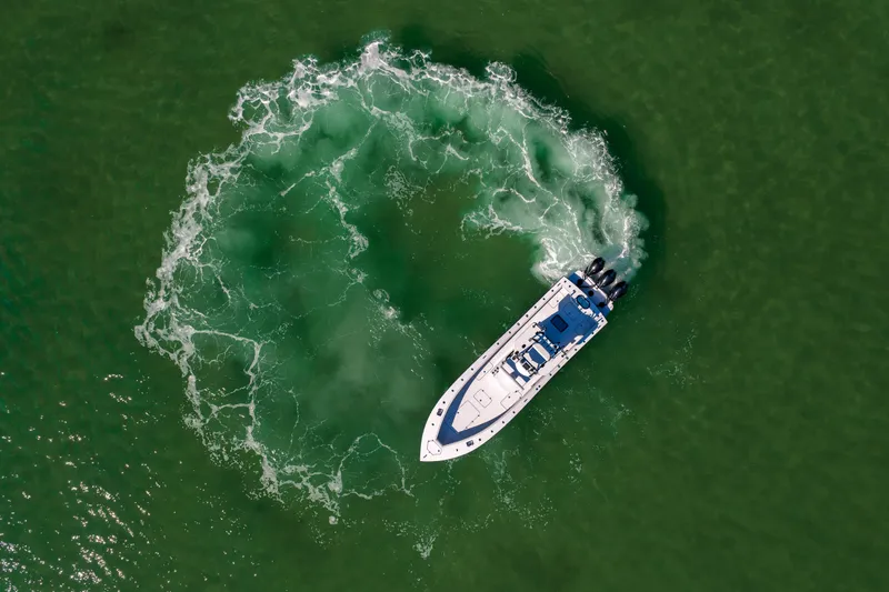 Slide: The Image of Aerial view of 2025 Conch 33 boat making a circular wake in green water. - 28