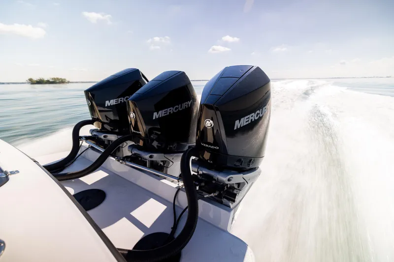 Slide: The Image of Triple Mercury outboard engines on 2025 Conch 33 boat, speeding on open water. - 29