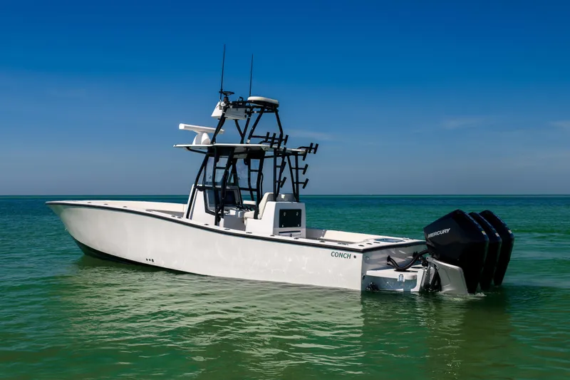 Slide: The Image of 2025 Conch 33 boat on clear turquoise water under blue sky. - 3