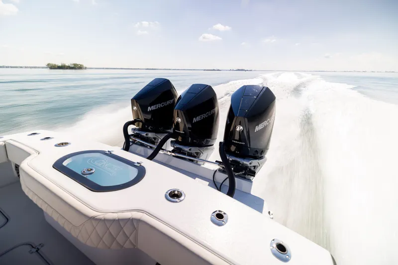Slide: The Image of 2025 Conch 33 boat with triple Mercury engines speeding on open water. - 30