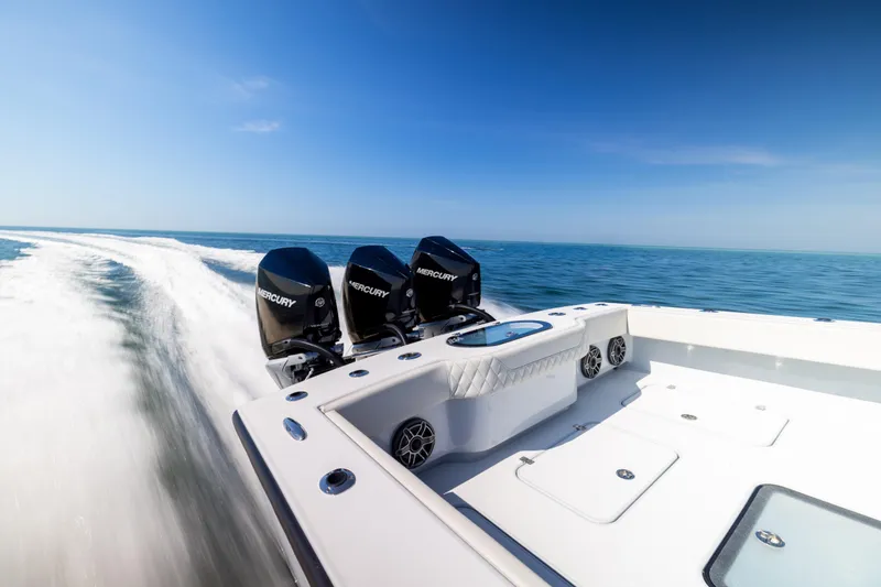Slide: The Image of 2025 Conch 33 boat with triple Mercury engines cruising on open water. - 31