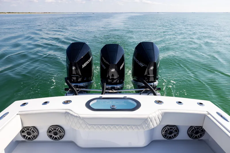 Slide: The Image of 2025 Conch 33 boat with triple Mercury engines on open water. - 33