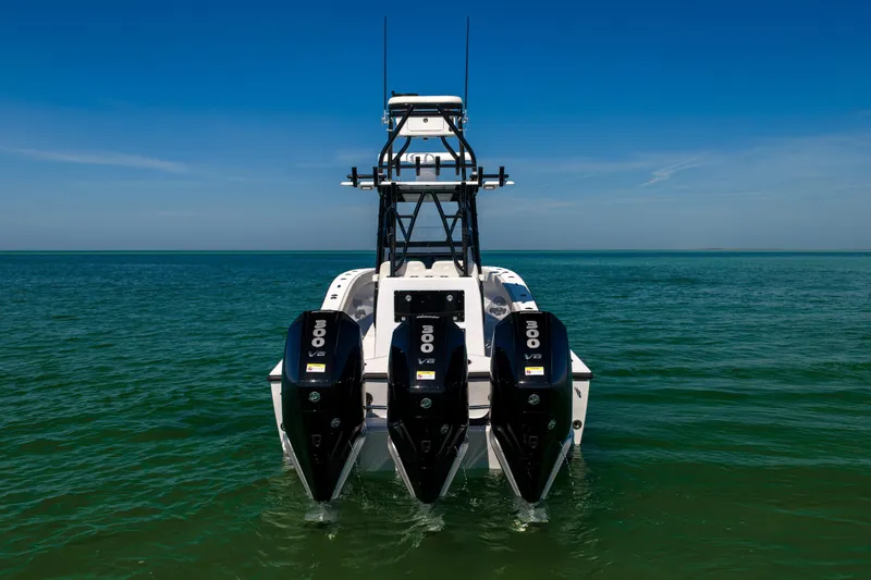 Slide: The Image of 2025 Conch 33 boat with triple outboard engines on open water. - 5