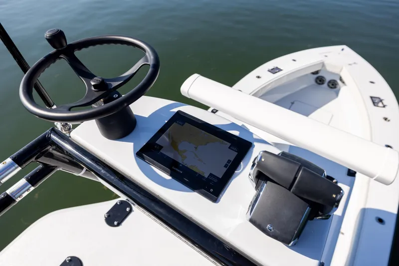 Slide: The Image of Steering console of 2025 Conch 33 boat with navigation display and controls. - 58