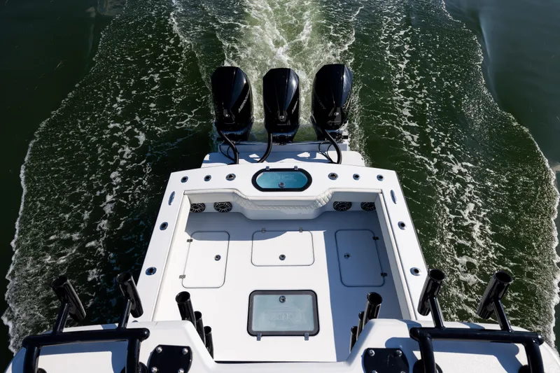 Slide: The Image of Aerial view of 2025 Conch 33 boat with triple engines on water. - 60