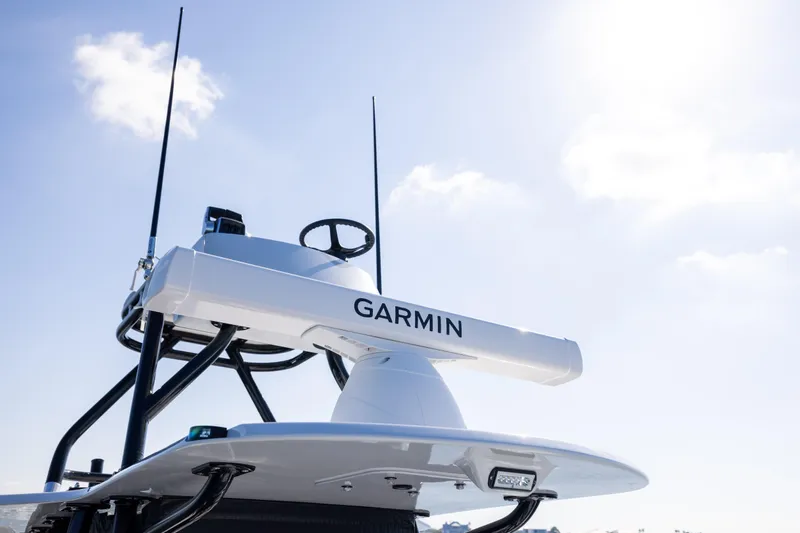 Slide: The Image of 2025 Conch 33 boat with Garmin radar against a clear blue sky. - 62