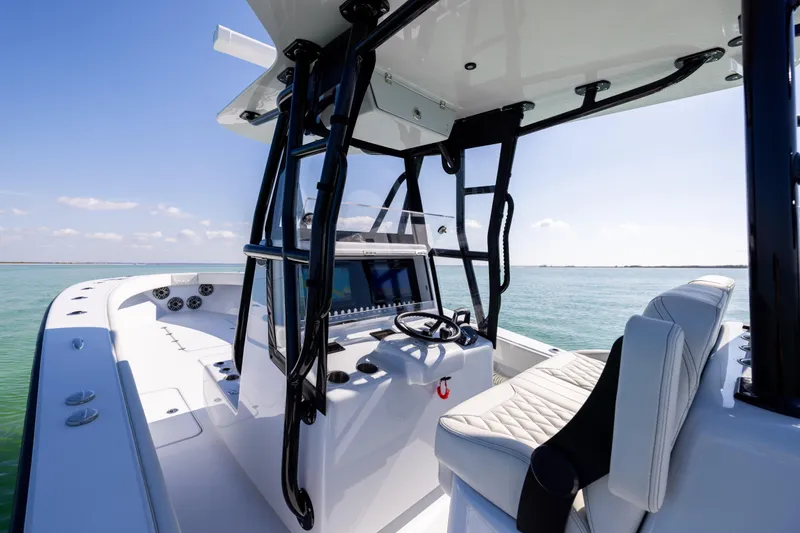Slide: The Image of 2025 Conch 33 boat interior with modern helm and seating on calm water. - 66