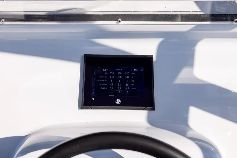 Slide: The Image of Digital display on 2025 Conch 33 boat dashboard showing engine metrics. - 71