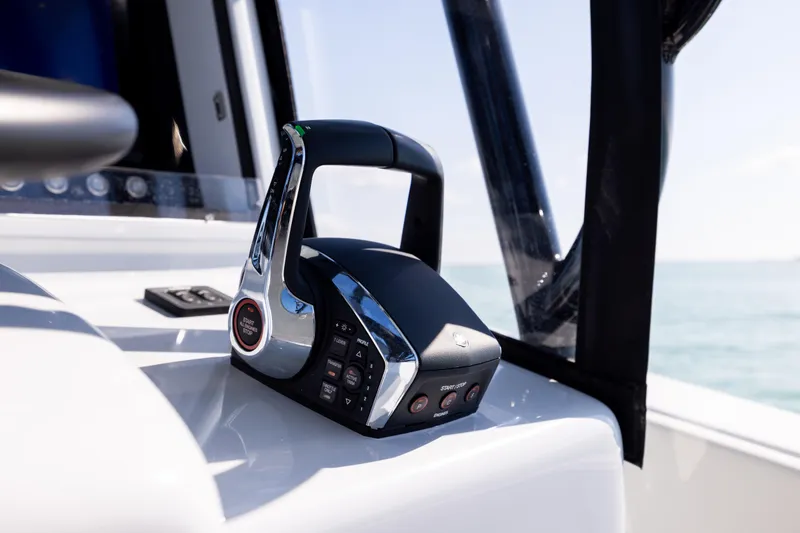 Slide: The Image of 2025 Conch 33 boat throttle control on a sunny day at sea. - 72