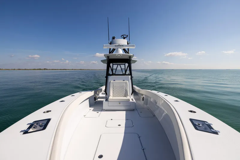 Slide: The Image of 2025 Conch 33 boat cruising on calm ocean waters under clear blue sky. - 73