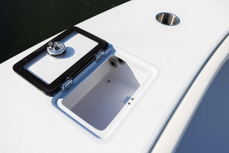 Slide: The Image of Open storage compartment on 2025 Conch 33 boat deck, featuring a secure latch. - 81