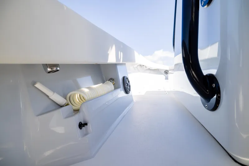 Slide: The Image of Interior view of 2025 Conch 33 boat, featuring storage compartment and handle. - 88