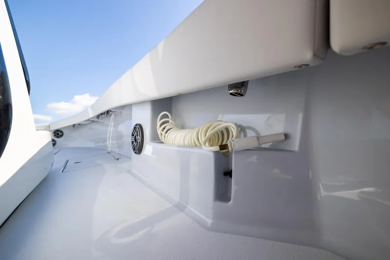 Slide: The Image of 2025 Conch 33 boat deck with coiled hose and speaker. - 89