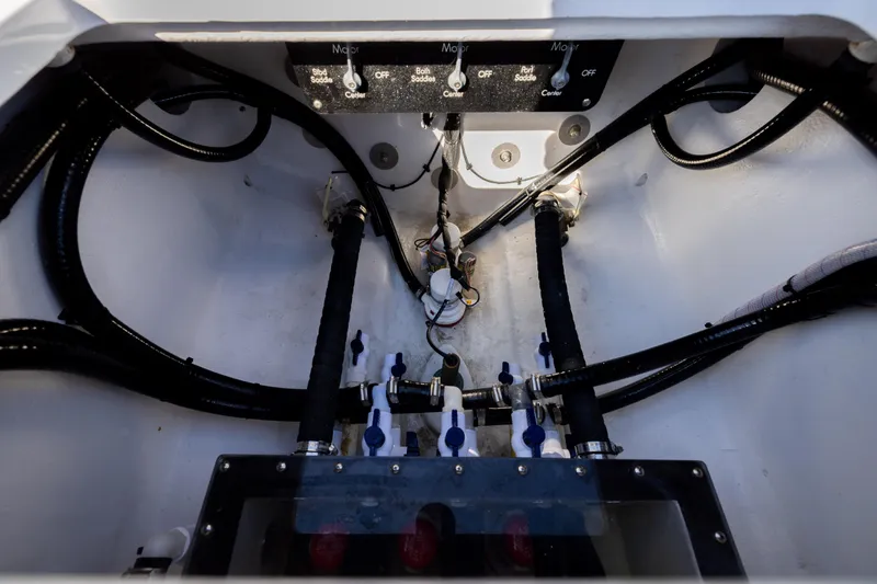 Slide: The Image of Engine compartment of 2025 Conch 33 boat with visible wiring and controls. - 93