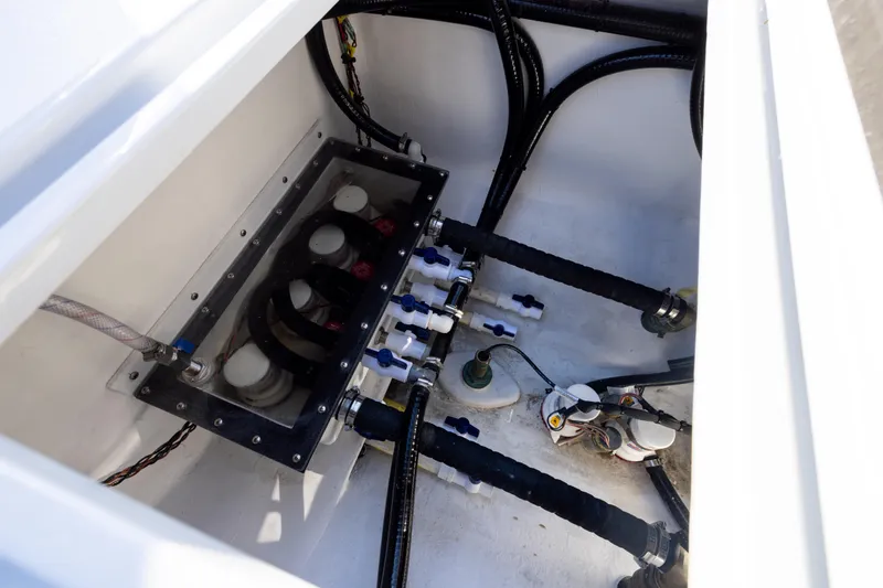 Slide: The Image of Engine compartment of 2025 Conch 33 boat, showcasing hoses and wiring. - 94