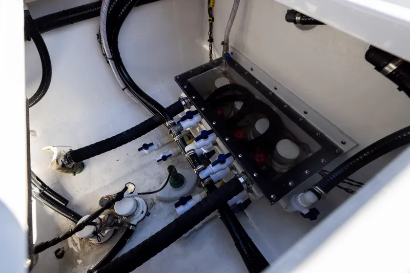 Slide: The Image of Engine compartment of 2025 Conch 33 boat with visible hoses and fittings. - 95